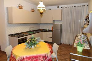 a kitchen with a table with a yellow table cloth at Lovely Tuscan Country House in Siena +25 photos