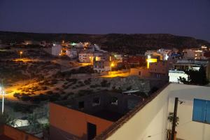 a view of a city at night at Bayti surf hostel in Agadir