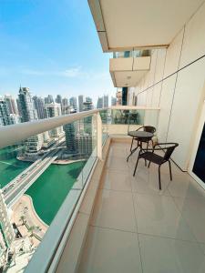a balcony with a table and chairs on a building at Jewellery Homes in Continental tower Dubai Marina in Dubai