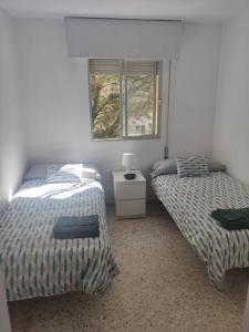 Posteľ alebo postele v izbe v ubytovaní Amplio apartamento junto a la Playa Victoria