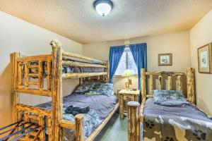 a bedroom with two bunk beds and a window at 4 Mi to Pine Lake Hathaway Pines Cabin with Deck in Hathaway Pines