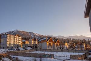 a group of buildings in the snow at COSY Appartment in Bakuriani