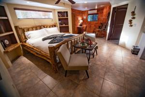 a bedroom with a bed and a table and a chair at The Inn at Thunder Mountain in Sedona