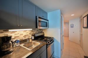 a kitchen with a sink and a stove at Spectacular Ocean Front Real 1 Bedroom Condo, 2 Ba in Myrtle Beach