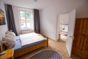 a small bedroom with a bed and a window at Apartment Yellow in Sigmarszell