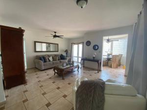 a living room with a couch and a table at Villa Del Carmen Family Vacation Home in Isabela