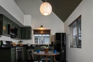 a kitchen with green cabinets and a small table at Hotel Marina Riviera in Big Bear Lake