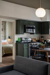 a kitchen with green cabinets and a table with chairs at Hotel Marina Riviera in Big Bear Lake