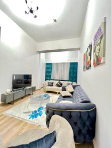 a living room with a couch and a tv at City centre Apartment in Esenyurt