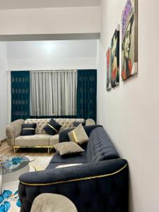 a living room with a large blue couch at City centre Apartment in Esenyurt