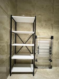a walk in closet with white shelving at City centre Apartment in Esenyurt