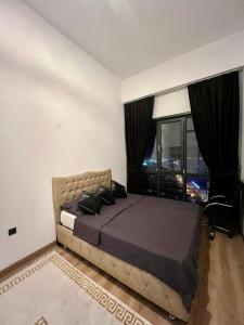 a bedroom with a large bed and a large window at City centre Apartment in Esenyurt