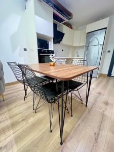 a wooden table and chairs in a kitchen at City centre Apartment in Esenyurt
