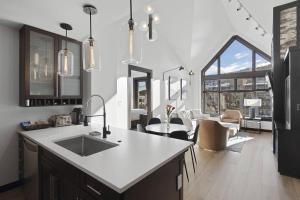 a kitchen with a sink and a living room at Capitol Peak 3518 in Snowmass Village
