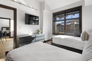a bedroom with two beds and a window at Capitol Peak 3518 in Snowmass Village