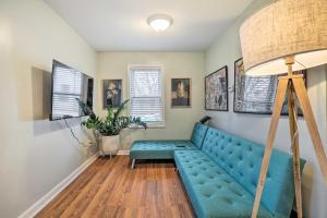 a living room with a blue couch and a lamp at Charming Warwick Vacation Rental Walk to Bay in Warwick