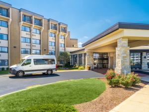 a white van parked in front of a building at Crowne Plaza Milwaukee South by IHG in Milwaukee