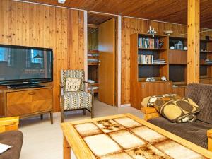 a living room with a tv and a couch and a table at 6 person holiday home in Ribe in Ribe