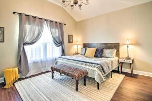 a bedroom with a bed and a large window at Chic Thomas Square Home in Walkable Location! in Savannah