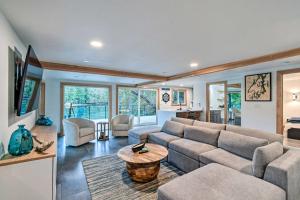 a living room with a couch and a table at Dreamy Bayfront Cabin with View, Dock and Kayaks in Olympia