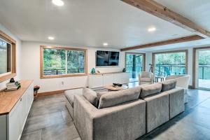 a living room with a couch and a table at Dreamy Bayfront Cabin with View, Dock and Kayaks in Olympia