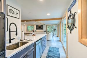 a kitchen with a sink and a counter top at Dreamy Bayfront Cabin with View, Dock and Kayaks in Olympia
