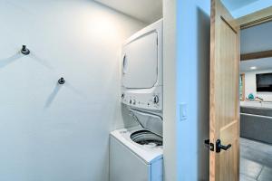 a washer and dryer in a room with a door at Dreamy Bayfront Cabin with View, Dock and Kayaks in Olympia