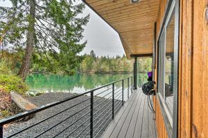 a porch of a house with a view of a lake at Dreamy Bayfront Cabin with View, Dock and Kayaks in Olympia