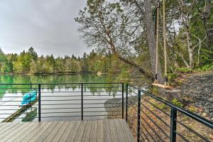 a wooden boardwalk leading to a lake at Dreamy Bayfront Cabin with View, Dock and Kayaks in Olympia