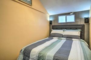 a bedroom with a bed with a window above it at Bright Texas Cottage Near San Antonio Zoo! in San Antonio