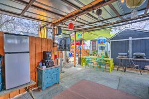 a patio with a refrigerator and a table with chairs at Bright Texas Cottage Near San Antonio Zoo! in San Antonio