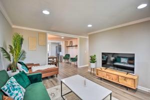 a living room with a couch and a tv at Modern Commerce House Rental with Fire Pit! in Commerce