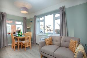 a living room with a couch and a table at Seymour House in Exmouth