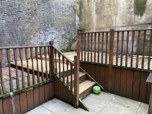 a wooden staircase with a tennis ball on the ground at One bedroom apartment near Dalston Station in London