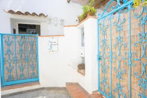 a gate to a house with blue gates at La Bella Annacapri in Anacapri