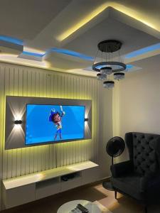 a living room with a flat screen tv on a wall at GS HOMES in Lagos
