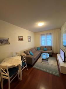 a living room with a couch and a table at Sweet Apartments in Žabljak