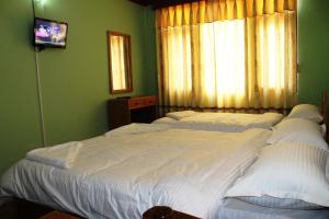 Postel nebo postele na pokoji v ubytování Kathmandu Madhuban Guest House
