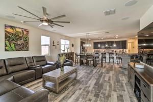 a living room with a couch and a table at Stunning Goodyear Vacation Rental with Private Pool! in Goodyear