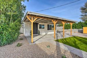 a pergola in front of a house at Phoenix Vacation Rental Home - Pet Friendly! in Phoenix