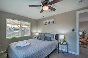 a bedroom with a bed and a ceiling fan at Phoenix Vacation Rental Home - Pet Friendly! in Phoenix