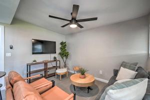 a living room with a couch and a ceiling fan at Pet-Friendly Phoenix Vacation Rental with Yard in Phoenix