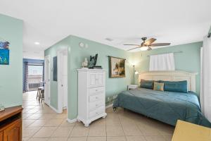 a bedroom with a bed and a ceiling fan at The American Dream in Gulf Shores