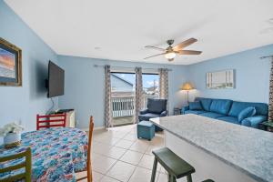 a living room with a blue couch and a table at The American Dream in Gulf Shores