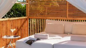 a white couch on a patio with a table at Crowne Plaza Florya Istanbul by IHG in Istanbul
