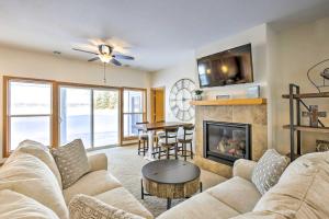 een woonkamer met een bank en een open haard bij Stunning Waterville Home on Tetonka Lake! 