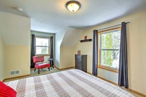 een slaapkamer met een bed, een stoel en een raam bij Stunning Waterville Home on Tetonka Lake! 