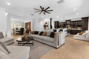a living room with two couches and a kitchen at Hidden gem! Gorgeous villa next to Disney in Kissimmee