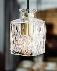 a glass vase with a light shining through it at Miss Clara by Nobis, Stockholm, a Member of Design Hotels™ in Stockholm
