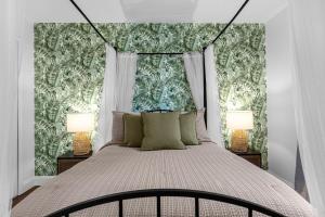 a bedroom with a large bed with two lamps at Hidden gem! Gorgeous villa next to Disney in Kissimmee +52 photos